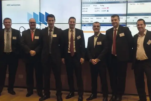 The Over the Wire team celebrating their listing on the Australian Securities Exchange.